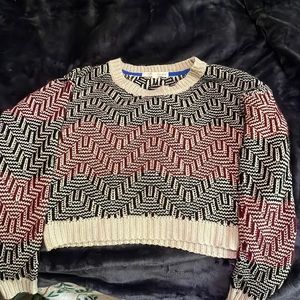 I am selling a tan, red, black zigzag striped long sleeve cropped shirt.